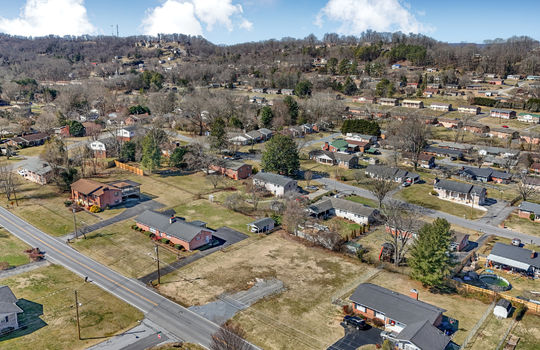 aerial view, 0.37+/- acres, road, neighboring properties, mountains