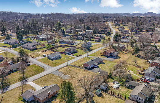 aerial view, 0.37+/- acres, road, neighboring properties, mountains