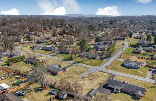 aerial view, 0.37+/- acres, road, neighboring properties, mountains