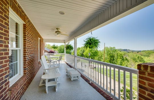 Covered front porch, ceiling fan, railing, brick home exterior, mountain views