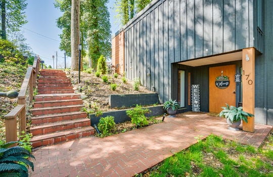 contemporary home, exterior entry door, brick stairs, wood siding