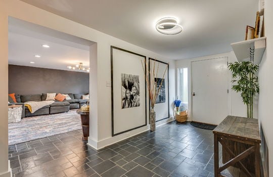 foyer, entryway, tile flooring, front door, doorway to living room