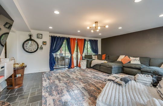 living room, tile flooring, recessed lighting, door to back patio area