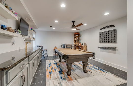 flex room, game room, tile flooring, wetbar, granite counters, cabinets, recessed lighting, ceiling fan