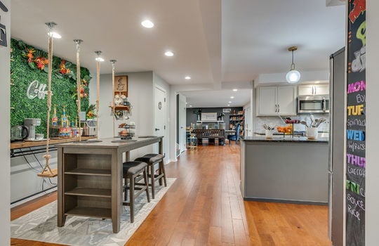 dining space, coffee bar, recessed lighting, swing seating, hardwood flooring.