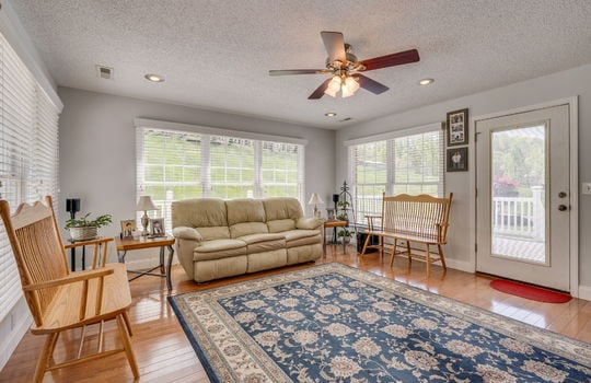 living room, hardwood flooring, windows, exterior door to back deck, ceiling fan, recessed lighting