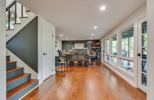 formal dining space, hardwood flooring, stairs to upper level, recessed lighting