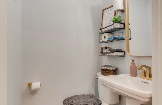 half bath, sink, toilet, hardwood flooring