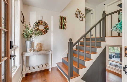 stairs to upper level, landing, hardwood flooring, railing