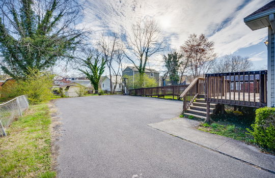 driveway, landscaping, handicap accessible ramp, stairs, wood railings, fencing