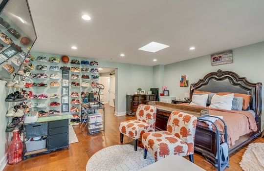 primary bedroom, hardwood flooring, recessed lighting, skylight,