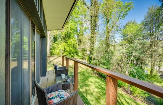 upper level balcony, railing, glass doors, back yard view, trees