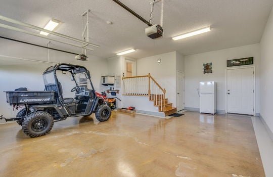 garage, concrete flooring, interior entry door, exterior door, garage door openers