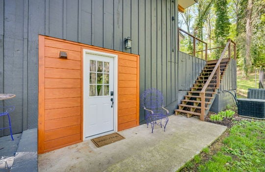exterior door, lower level door, stairs to upper level deck, back yard, concrete pad