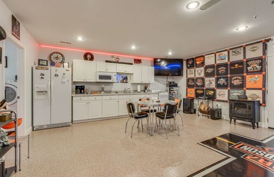 lower level kitchen, concrete flooring, cabinets, countertops, sink, refrigerator, oven/range, built in microwave, recessed lighting