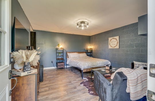 bedroom, block wall, hardwood flooring