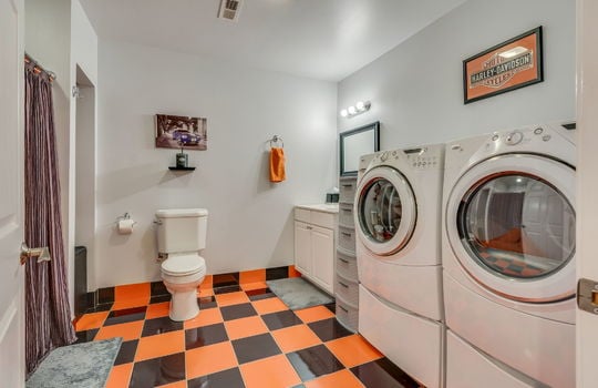 bathroom, tile flooring, toilet, sink, shower, washer/dryer hookups