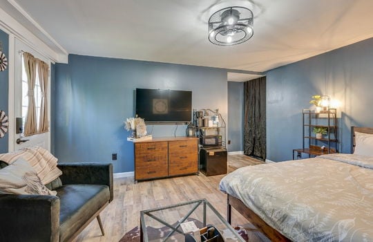 bedroom, exterior door, hardwood flooring