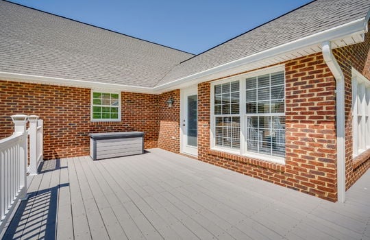deck, exterior entry, roof, brick exterior, windows, railing, steps
