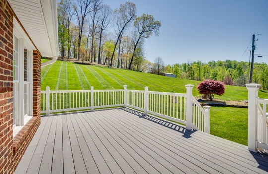deck, back yard, brick home exterior, railing, trees