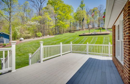 deck, brick exterior, back yard, outbuilding, landscaping, trees