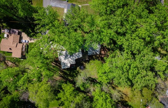 aerial view of home, trees, neighboring properties