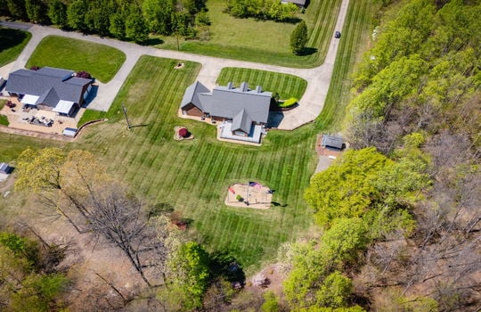aerial view of home, back yard, roof, front yard, driveway, trees, neighboring home