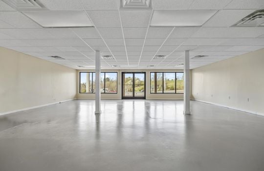Open floor plan, ceiling tiles, glass windows, glass doors, fluorescent lighting