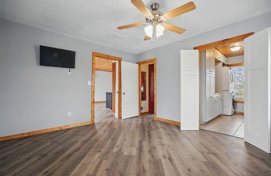 bedroom, luxury vinyl flooring, wood trim, closet, bathroom, walk in closet with laundry hookups, windows, ceiling fan, luxury vinyl flooring, tile flooring