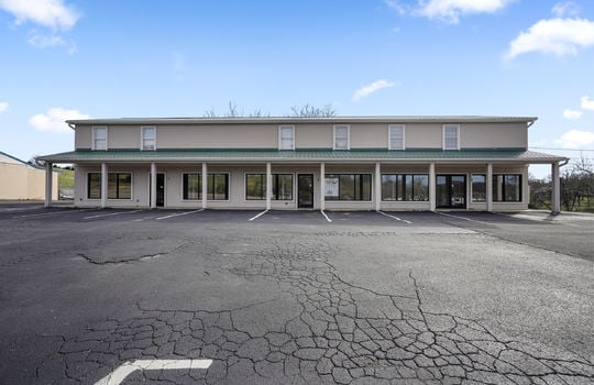 parking lot, commercial storefronts, covered entrances, metal roof