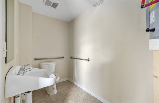 bathroom, sink, toilet, tile flooring, fluorescent lighting