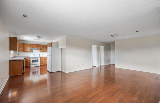living room, laminate flooring, open floorplan, refrigerator, dishwasher, oven/range, sink, cabinets, countertops