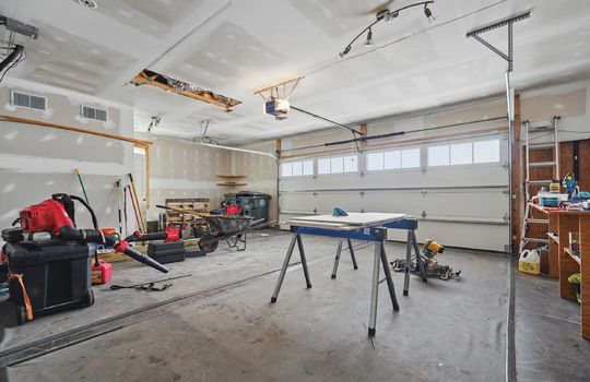 two car garage, workshop space, heated, garage door, concrete flooring