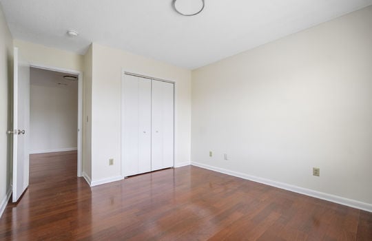 bedroom, closet, laminate flooring, door to hallway