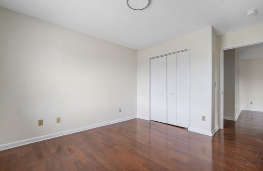 bedroom, closet, laminate flooring, door to hallway