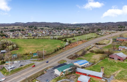 road, parking lot, commercial building, commercial space for lease, metal roof, neighboring properties, road, mountain views