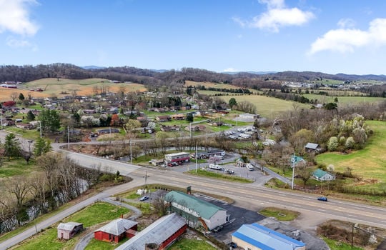 road, parking lot, commercial building, commercial space for lease, metal roof, neighboring properties, road, mountain views
