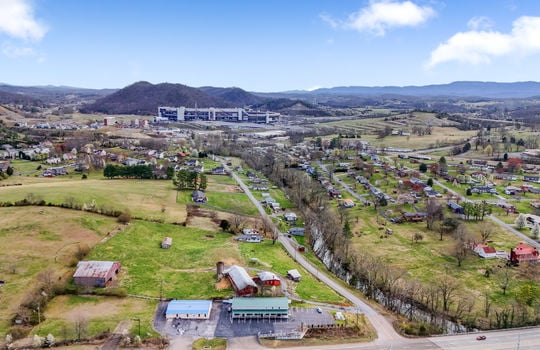 road, parking lot, commercial building, commercial space for lease, metal roof, neighboring properties, road, mountain views