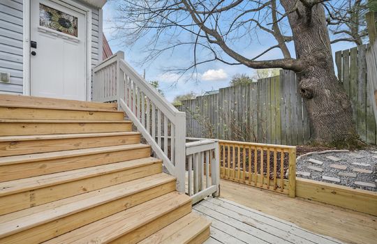 stairs to front door, wood stairs, deck, vinyl siding, metal roof, fencing