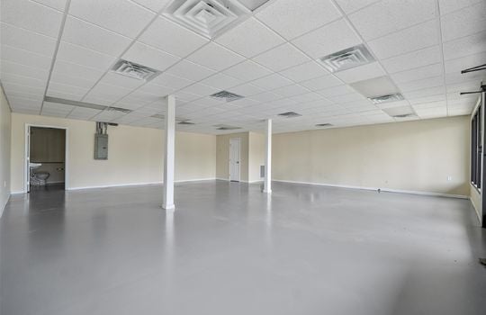 Open floor plan, ceiling tiles, glass windows, glass doors, fluorescent lighting