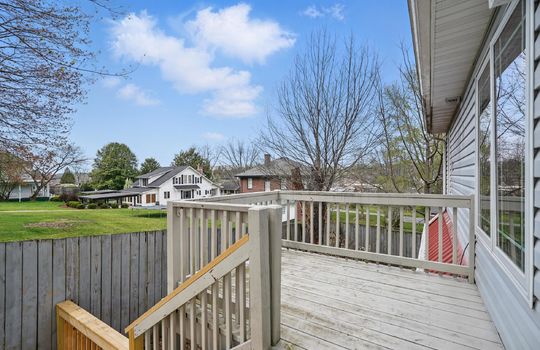 deck, fencing, view of neighborhood, vinyl siding, metal roof