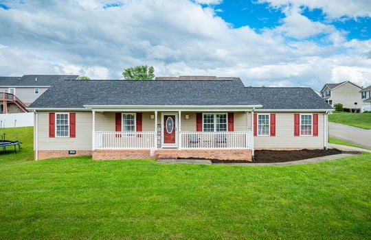 ranch style home, front porch, covered front porch, vinyl siding, front door, roof, yard