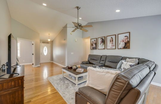 living room, vaulted ceiling, recessed lighting, hardwood flooring, ceiling fan, view toward front door