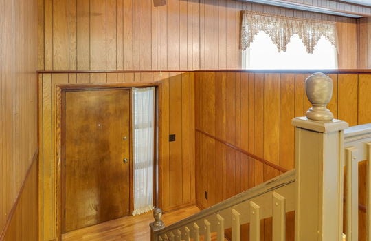 split level entry, wood landing, carpeted stairs, front door, ceiling fan