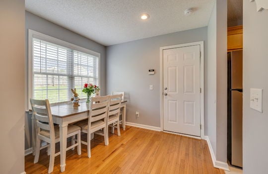 dining space, hardwood flooring, door, recessed lighting