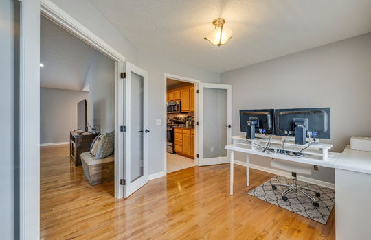 bedroom/office space, hardwood flooring, glass pane doors