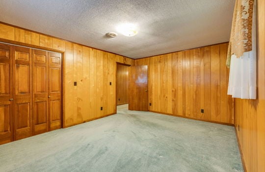 bedroom, paneling walls, carpet, windows, closet