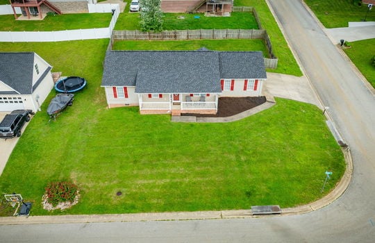 aerial view toward front of home, ranch style home, front yard, landscaping, driveway, back yard, fenced back yard