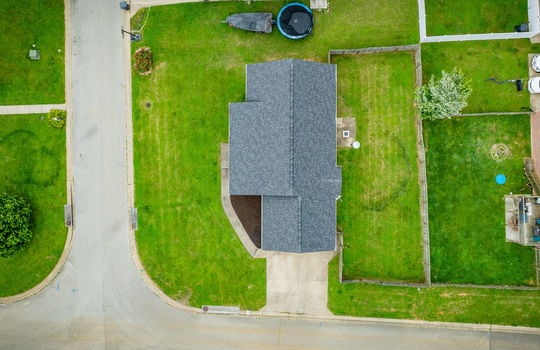 overhead aerial view of home, roof, front yard, fenced back yard, patio, driveway, road