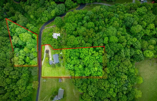 Aerial view of property, property outline, trees, road, neighboring properties